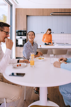 Casual Business Team Having Breakfast Meeting in Modern Open-Plan Kitchen Office