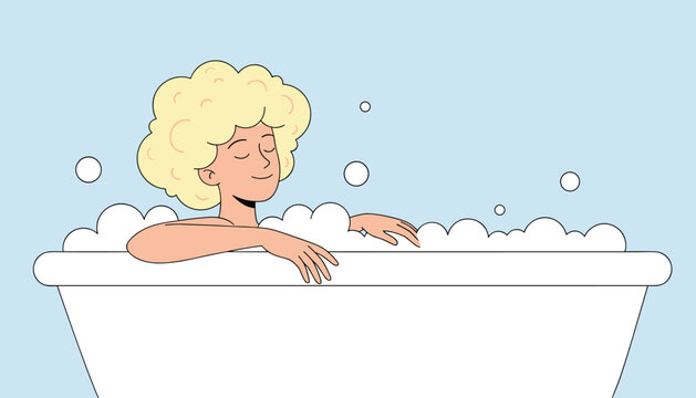 Woman with blonde hair enjoys a relaxing bubble bath in a white tub against a serene light blue background for self-care and wellness.