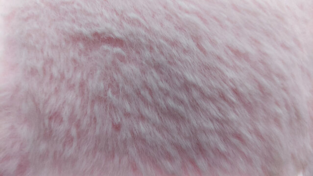 Soft pink plush or faux fabric textured polar rush background