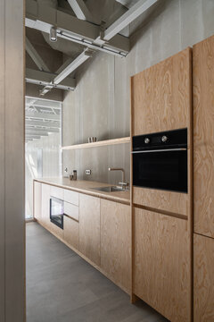 Compact Kitchen Integrated into Hangar Workspace