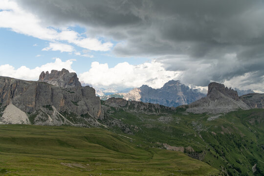 Selva di Cadore, Italy. Dramatic Dolomites mountain landscape near Mondeval with alpine plateau, rugged rock formations and storm clouds