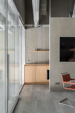 Minimalist office kitchenette inside a converted aircraft hangar
