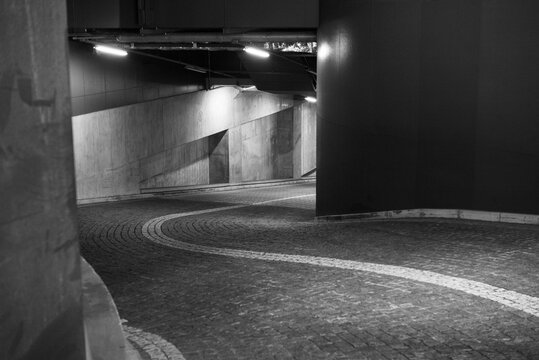 Curved Underground Parking Ramp in Black and White