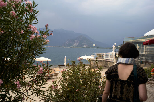 Walking by the Water Near the Mountains Under Cloudy Skies