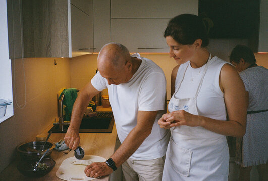 Family making homemade fried pastries together