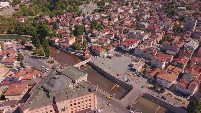 Aerial Drone Ascending View Over Vijecnica City Hall and Miljacka River Bridges in Sarajevo