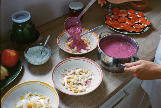 Anonymous person serving cold beetroot soup