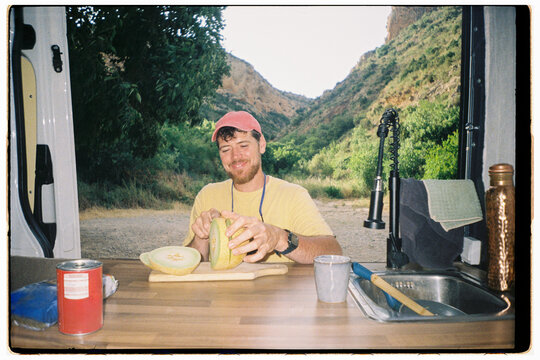 Man Cuts Fruit in a Van
