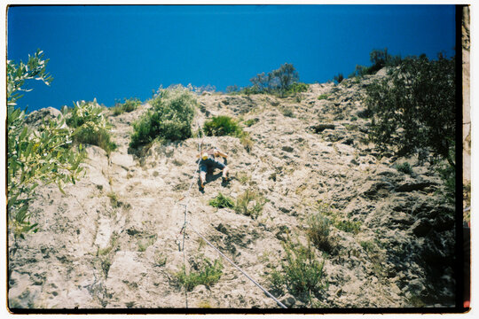 man climbing rock wal