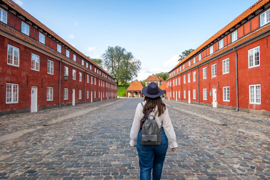 Person walking along historic barracks in Copenhagen Denmark