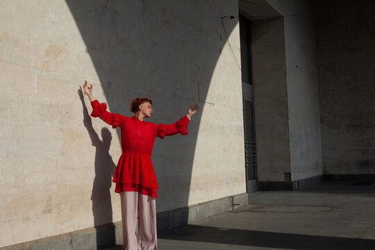 A woman in the red in the beige space