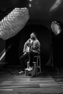 Creative subject posing in professional studio setup