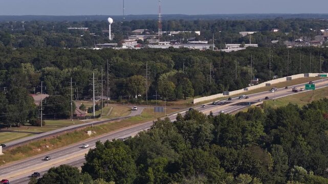 Aerial of highway passing through suburban and forested area in Springfield Missouri