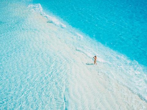 Tropical white sandy beach with ocean water. Aerial view, top down