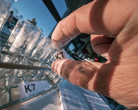 Personalized medicine cryovial with a K7 label being handled by a gloved hand for precision medicine and oncology research, with copy space