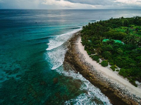 Drone view of sea with waves and coastline on Fuvahmulah island in Maldives