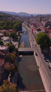 Aerial View of Miljacka River and Bridges in Historic Sarajevo City Center Reveal Shot