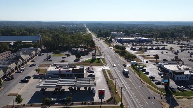 Aerial of suburban commercial corridor and highway in Springfield Missouri with large strip mall complexes and parking lots