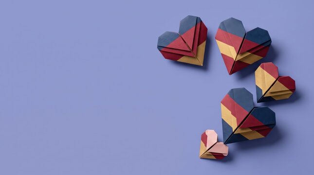 origami hearts in different colors on purple background