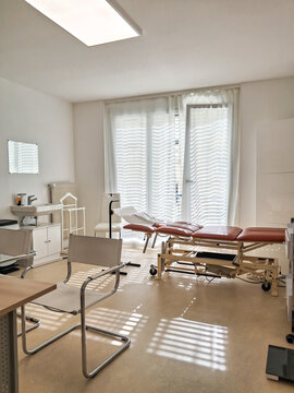 Empty doctor observation room with modern white clinical aesthetic and light.