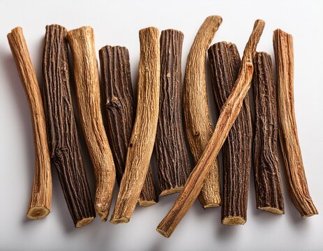 dried licorice root sticks arranged on a white background