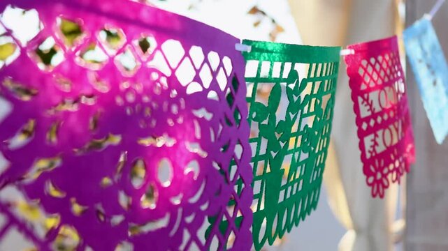 Colorful papel picado banners for Day of the Dead outdoor decoration in a festive streetscape