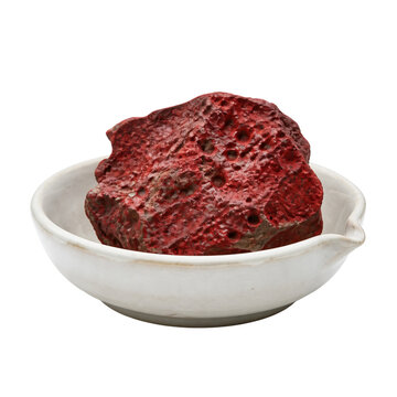 Porous red cinnabar mineral in a white ceramic alchemy bowl isolated on transparent background PNG element