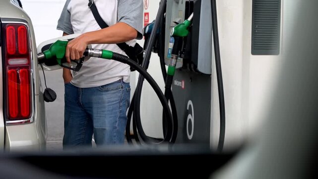 Driver refueling car at gas station