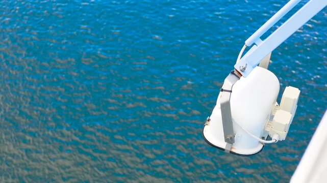 Marine Spotlight Mounted over Blue Deep Ocean Rippling Water Copy Space