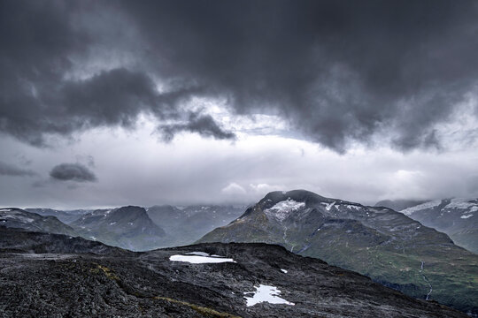 A dramatic landscape of a bare, rocky mountain peak. A beautiful summer scenery of Geiranger World Heritage area in Western Norway.