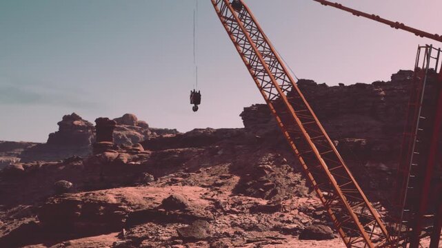 A daring scene unfolds as a crane hoists a platform high above stunning rocky terrain. The sun casts warm hues on the dramatic cliffs, creating a breathtaking backdrop for exploration.