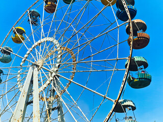 Ferris wheel in the amusement park on a background of blue sky © Igor