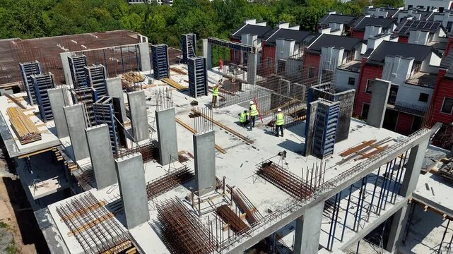 Overhead view of concrete columns rebar and forms at a building site in daylight, Infrastructure project demonstrates planning and property investment