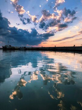 Processed with VSCO with k3 preset Beautiful dramatic sunset sky reflecting in calm water at a harbor
