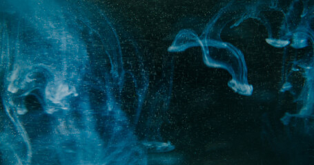 Defocused cloud paint. Blue splash pigment. Color smoke vapor bright stardust droplet water particles spreading on abstract background. © Photodrive