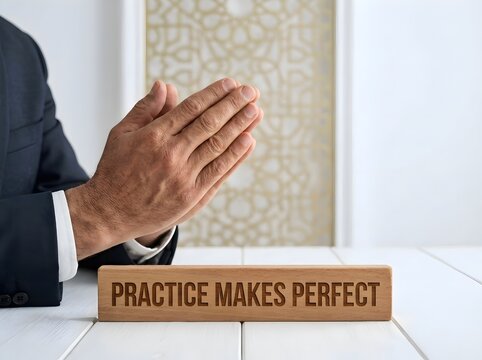 Practice Makes Perfect Motivational Message with Hand Touching Wooden Letter Blocks in Modern Setting