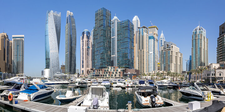Dubai Marina skyline cityscape with yachts hotel skyscraper buildings panorama living at water in Arabia