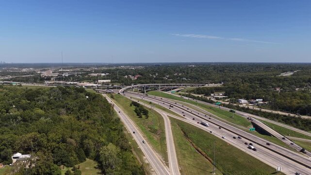 Aerial of multilane interstate 49 interchange in suburban forest in Kansas City Missouri in daytime