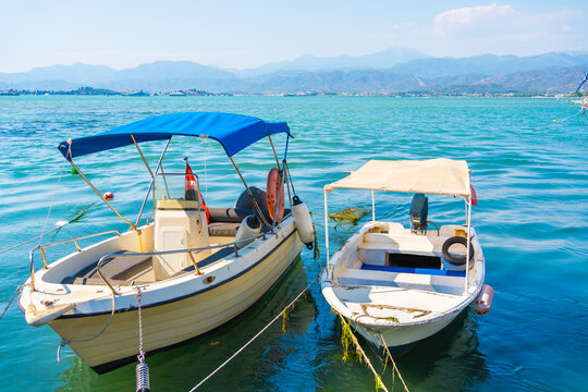 Fishing boats moored on the pier in Fethiye, Turkey.. Blue sea and the blue sky at sunny day.