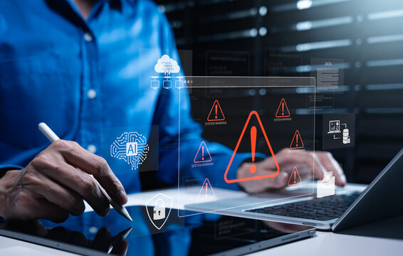 AI cybersecurity system warning interface with IT professional using laptop and tablet to monitor AI, cloud data and network threats. digital security, risk detection and incident response workflow