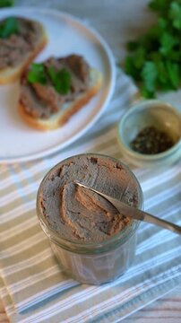 Spreading liver pate on toasted bread. Homemade beef liver pate for healthy snack or breakfast.