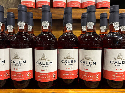 Bottles of portuguese pink port on a store shelf. Close-up. Porto. Portugal.