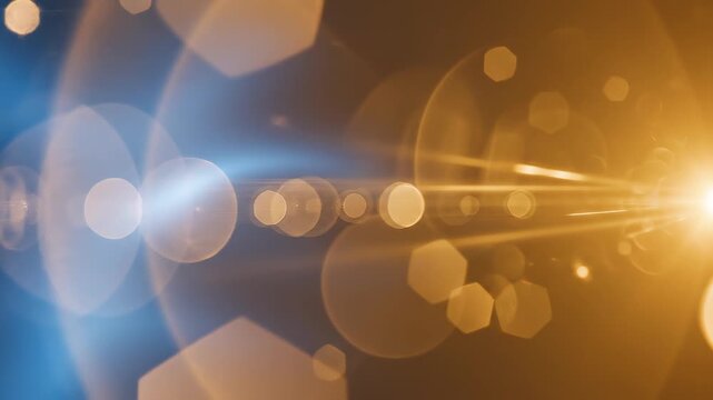 Abstract blue and gold light flares with bokeh and hexagonal particles during a cinematic transition