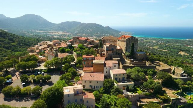 Pigna Corsica island aerial drone cinematic footage of hilltop village traditional red roof houses Balagne sea view panorama travel destination 4k video most beautiful villages of France