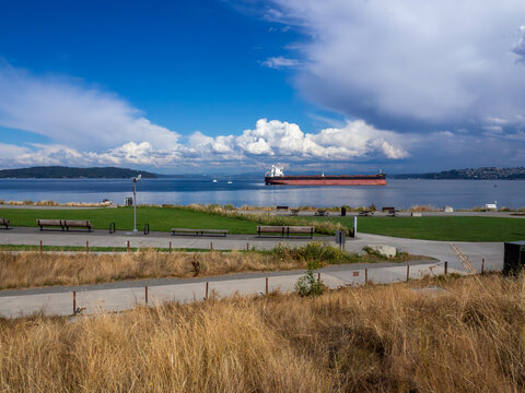 A beautiful day overlooking Dune Park in Tacoma Washington with lush lawns, inviting walkways and gorgeous views of Puget Sound's Commencement Bay with tanker at anchor.