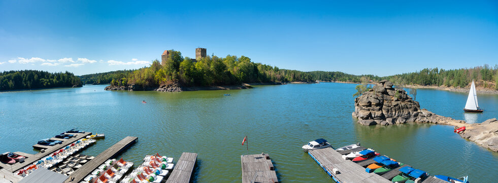 Panoramic view of Ottenstein reservoir with Lichtenfels castle ruin, boat dock and sailboat in Waldviertel Austria
