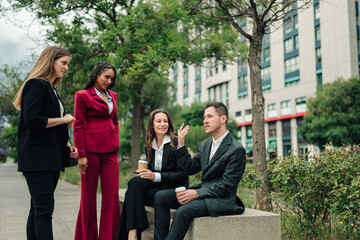 Fototapeta premium Business professionals discussing strategy outdoors, having a casual meeting in a city park environment, showing collaboration