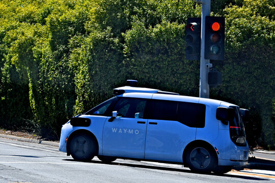 Blue van-style electric robotaxi, Ojai, by Waymo are available in metropolitan areas around San Francisco, Los Angeles and Phoenix 