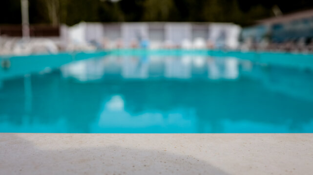 Tranquil turquoise swimming pool with lounge chairs and cabanas in the background