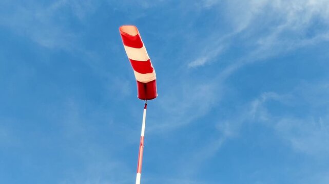  Red and white windsock showing wind direction at a small airfield